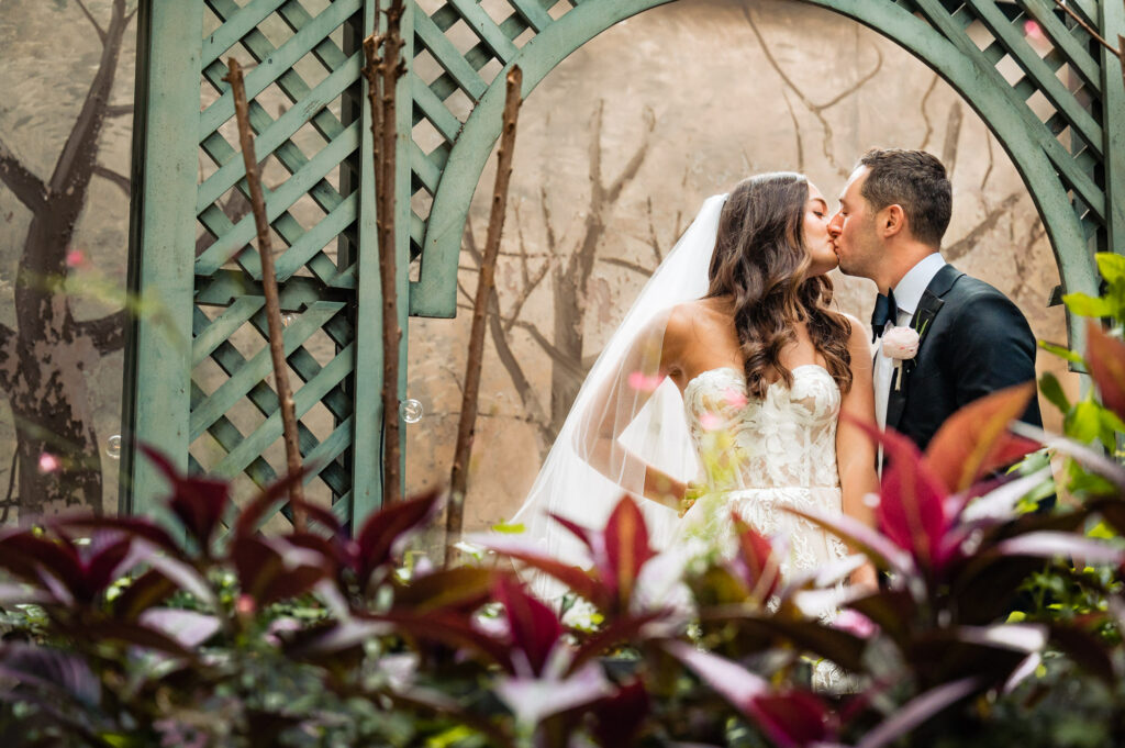 couple take a pose at the rittenhouse hotel's garden
