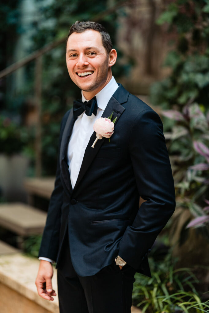 solo shot of the dashing groom smiling for the camera