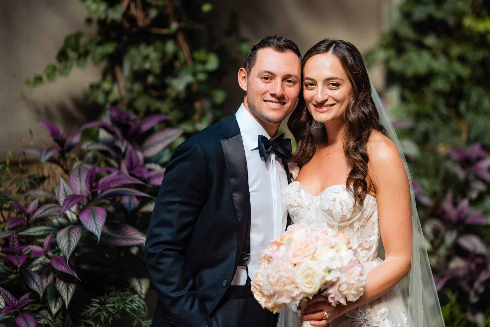 couple take a pose at the rittenhouse hotel's garden before their wedding ceremony