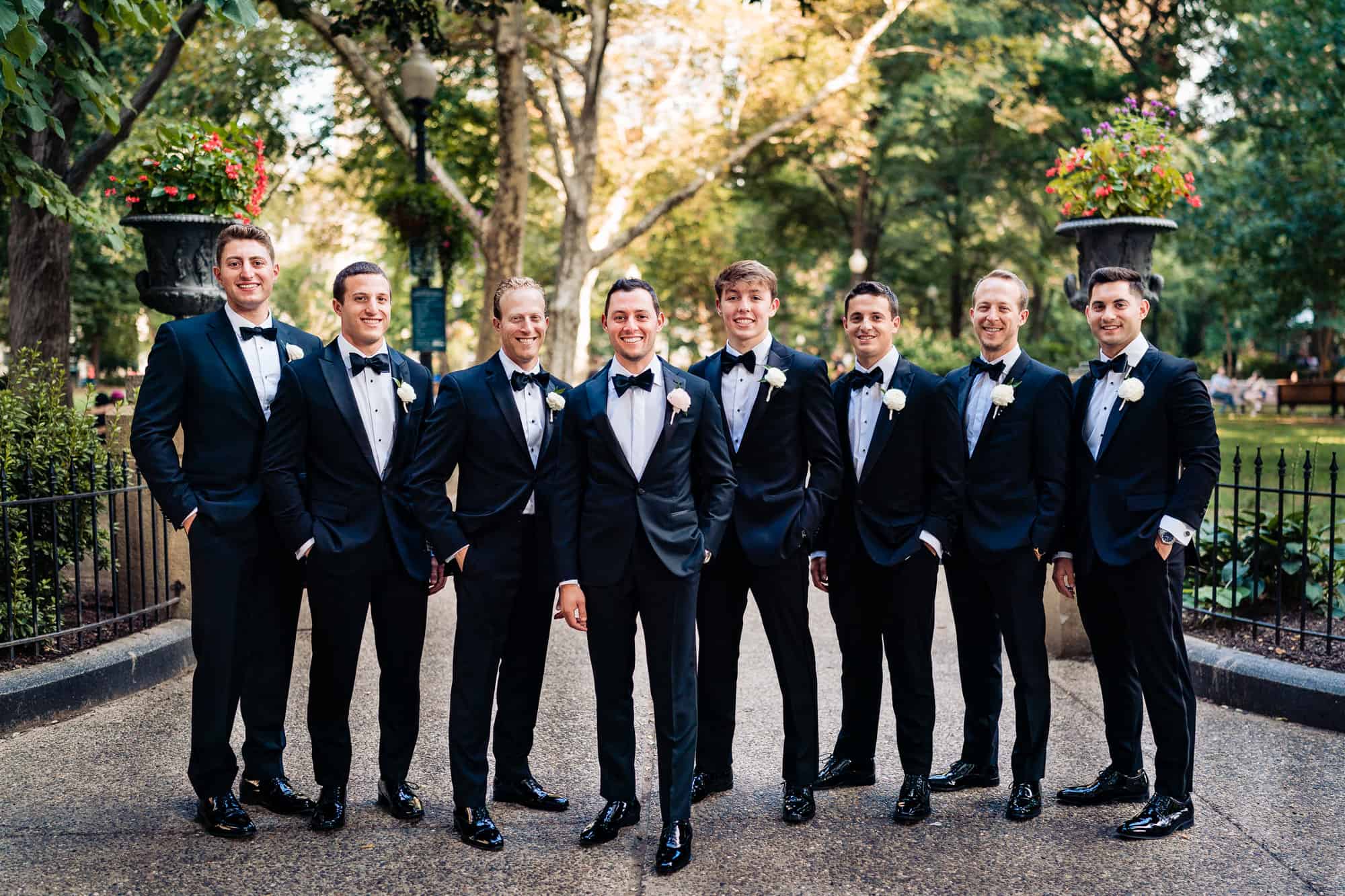 groom and his groomsmen taking a formal pose before the camera