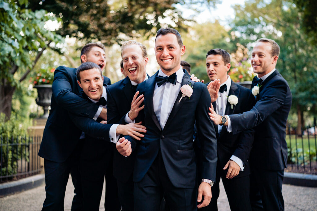 groom and his groomsmen having fun before the camera