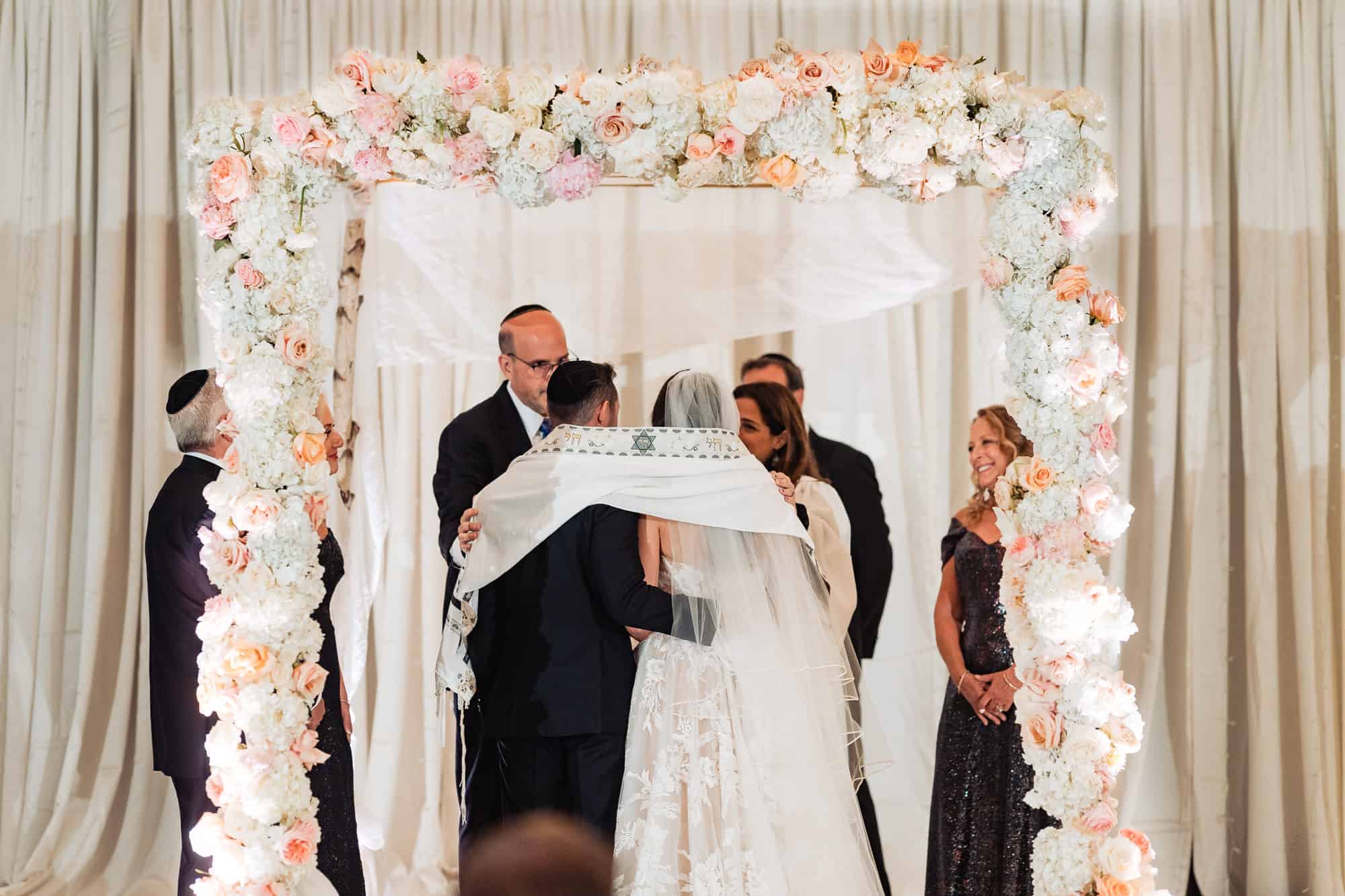 couple having their vows under the chuppah