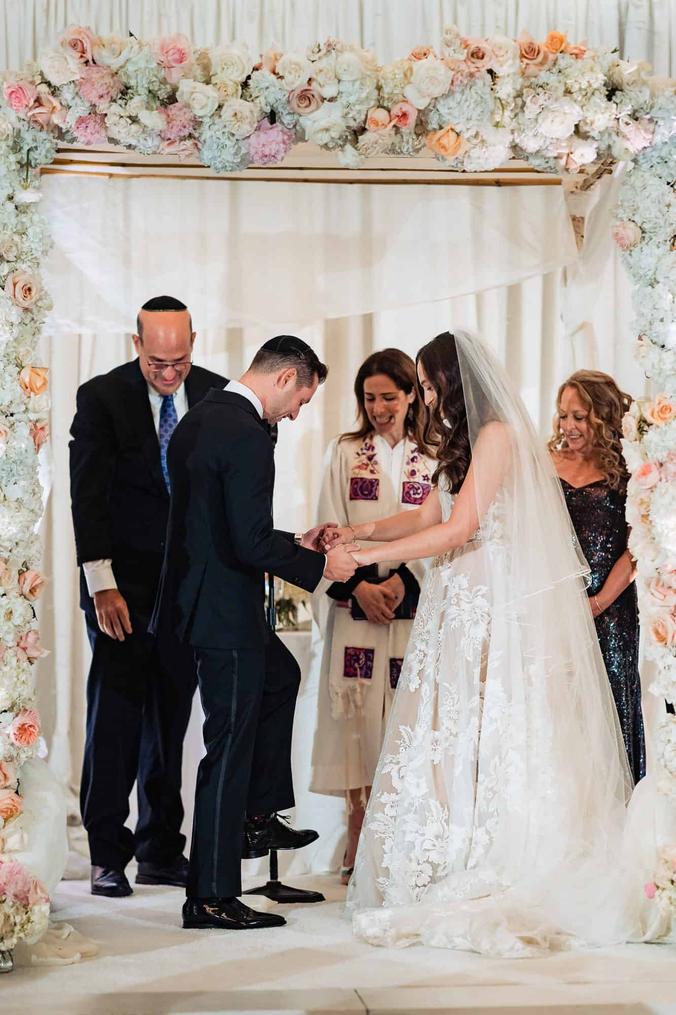 groom is stepping on the glass as part of their jewish tradition