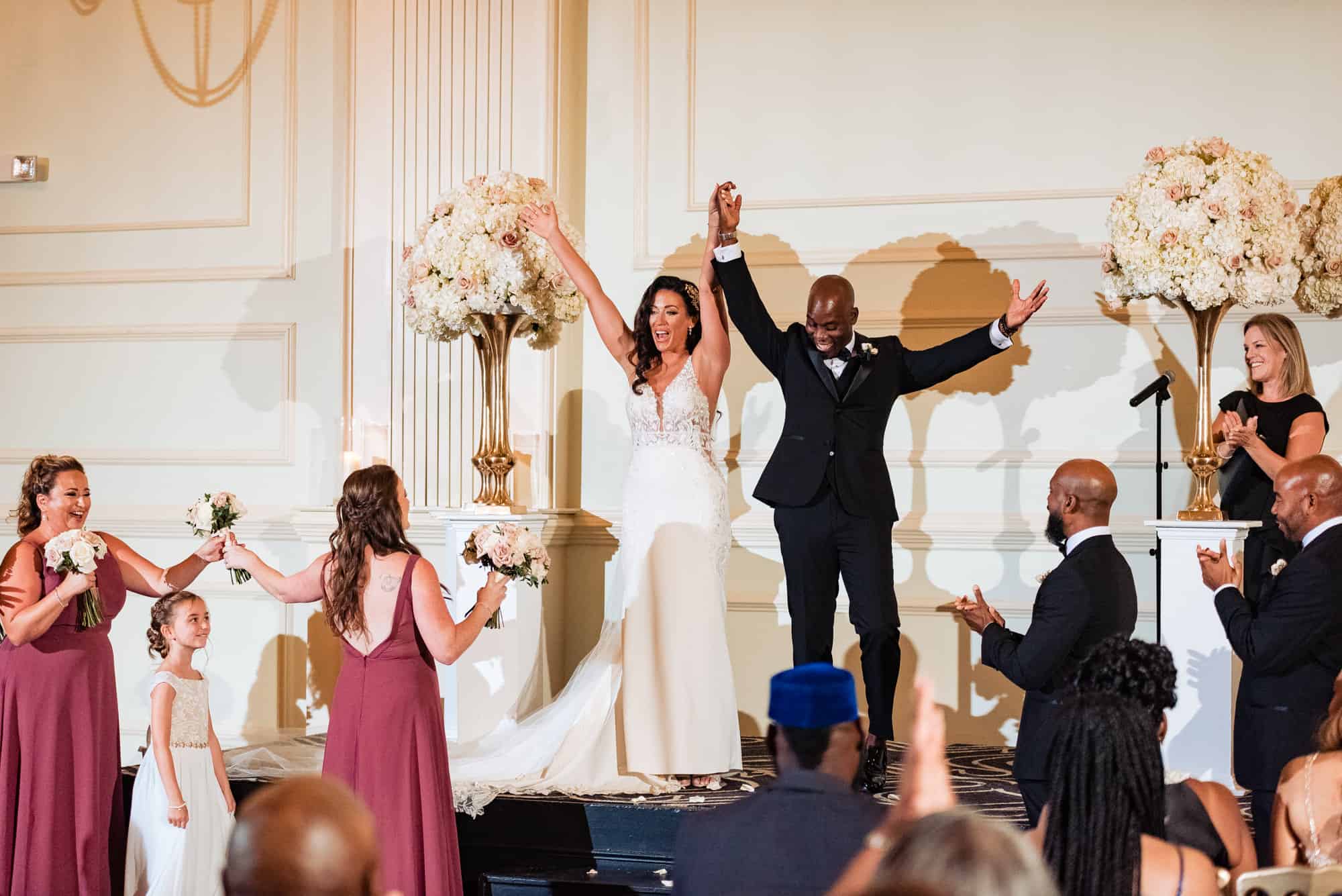 newlyweds getting praised by the guests during their wedding at cescaphe ballroom