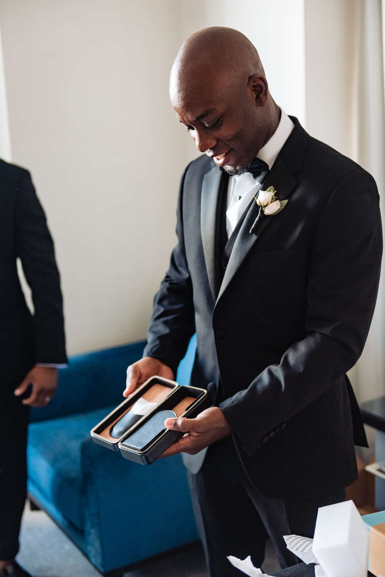 groom receiving a gift box from his bride