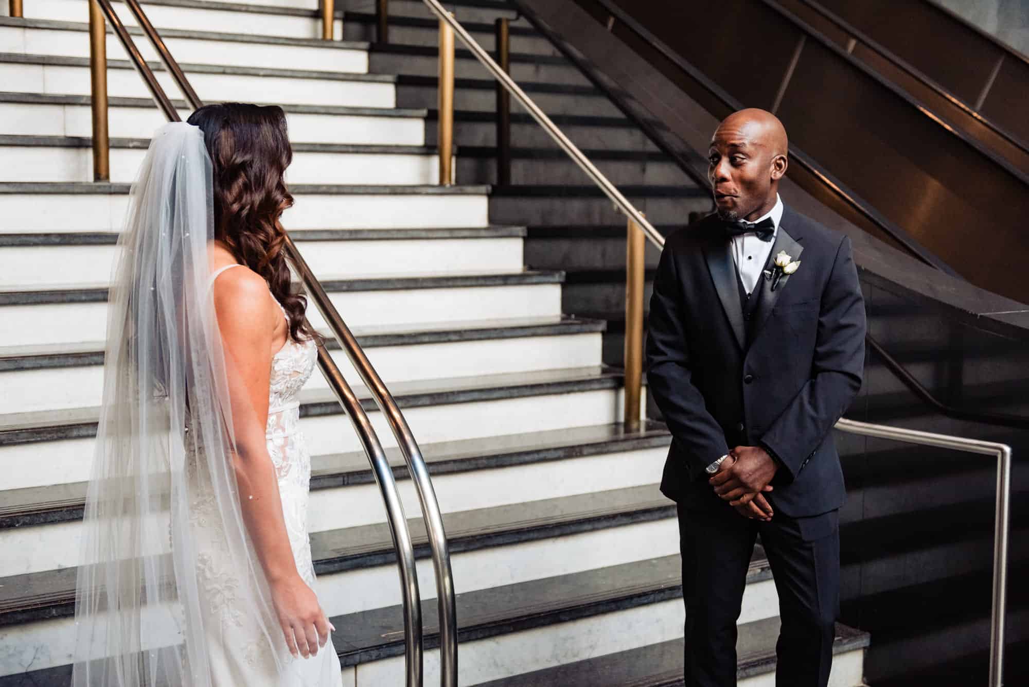 groom is stunned for their first look