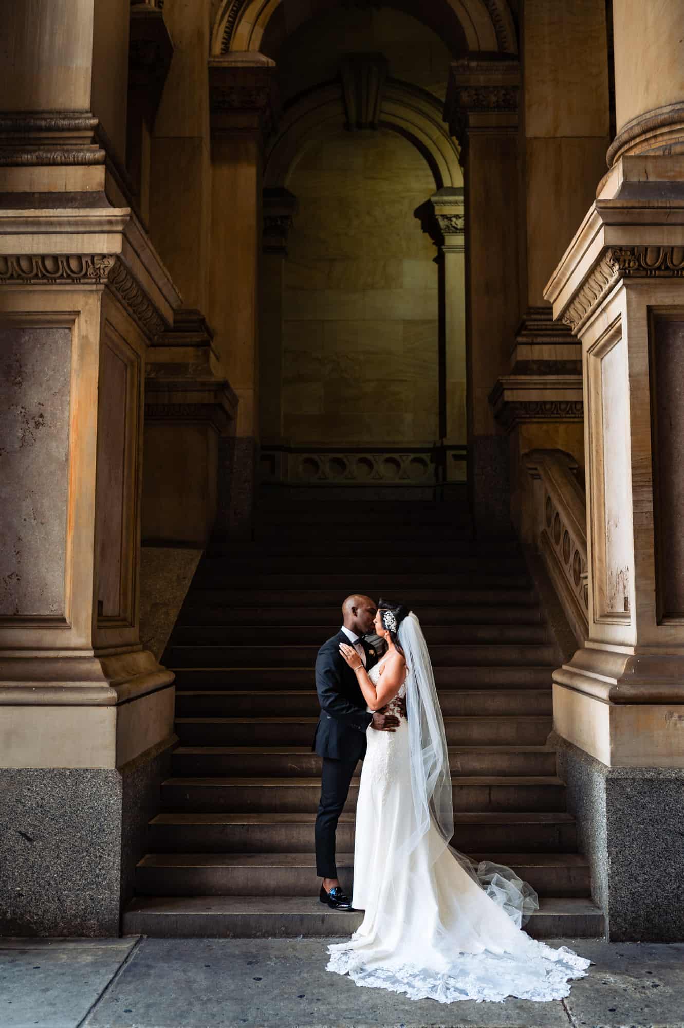 couple kissed beside a concrete post