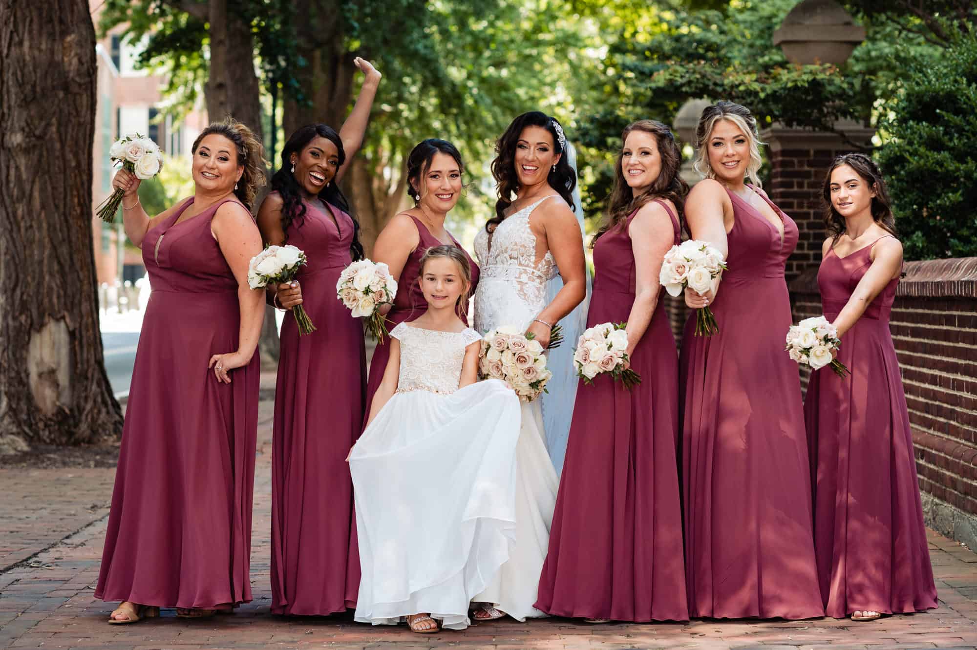 bride and her bridal party takes a wacky pose