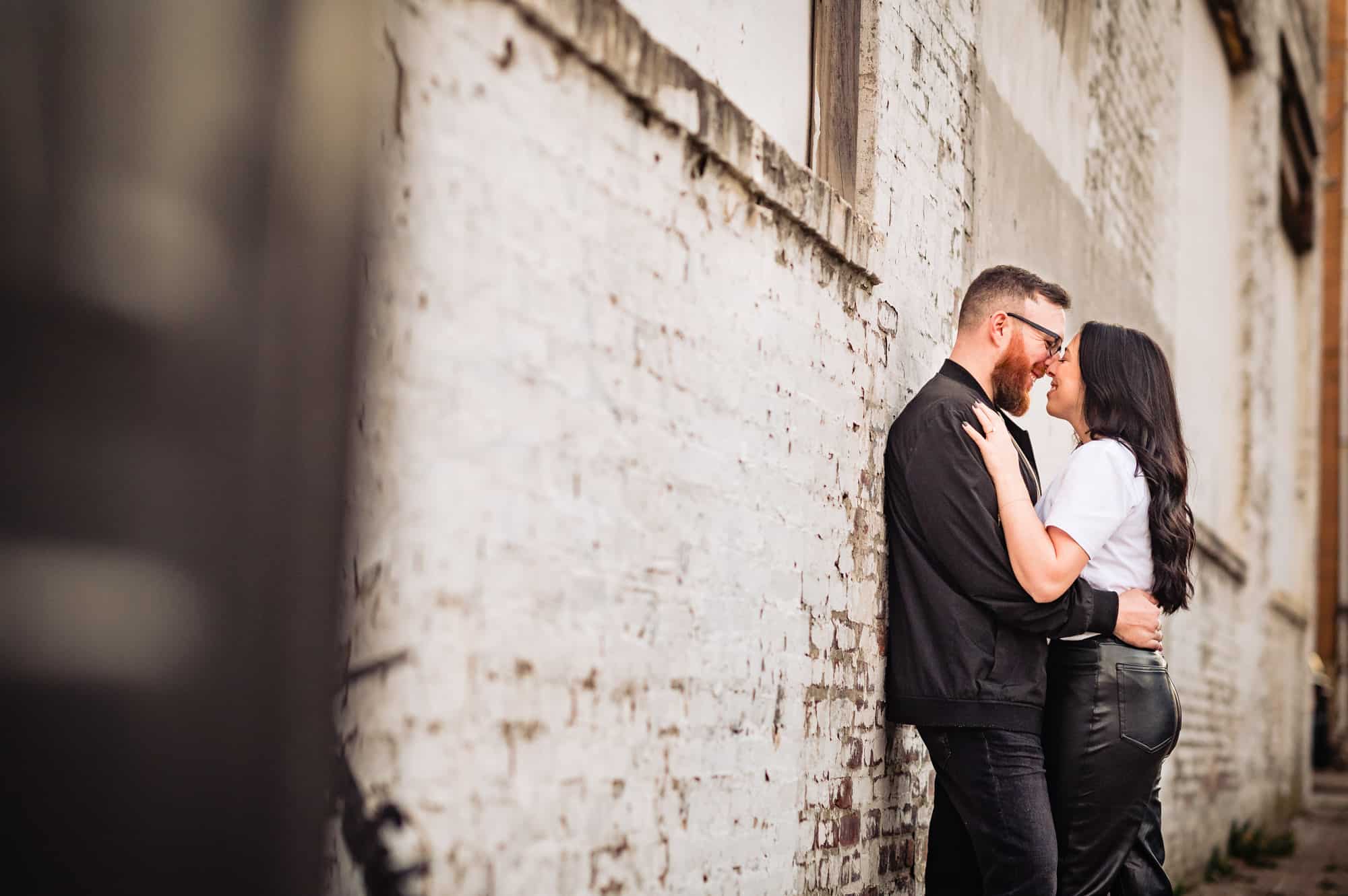 An engagement session in south Philadelphia was fun with the couple smiling before the camera along the street