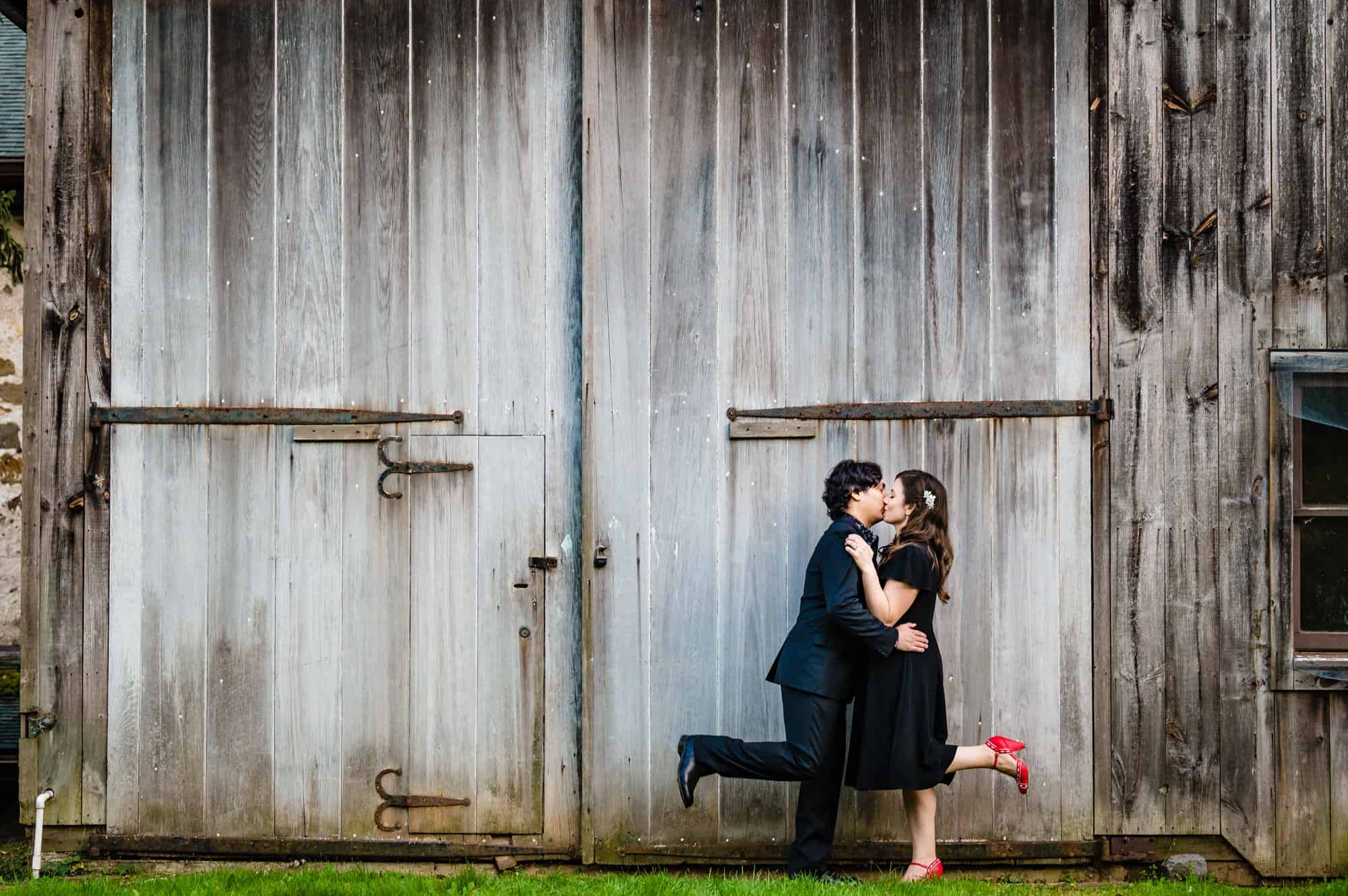 couple kisses for the camera during their engagement shoot