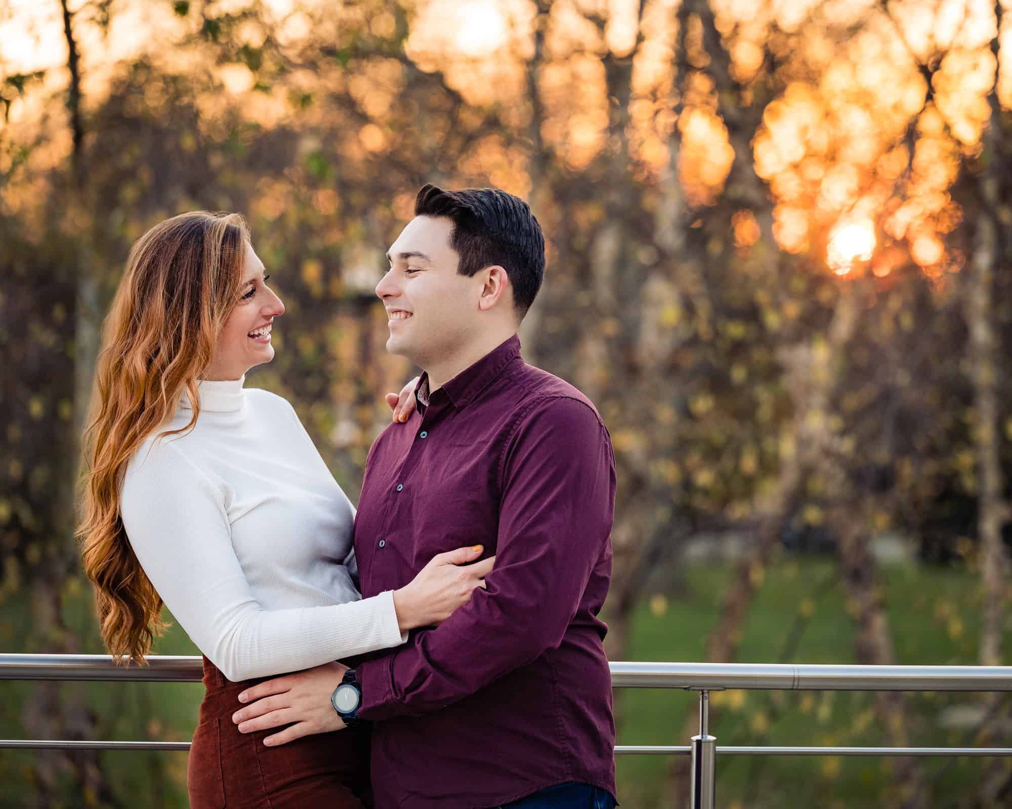 couple looking and smiling at each other during their engagement photoshoot