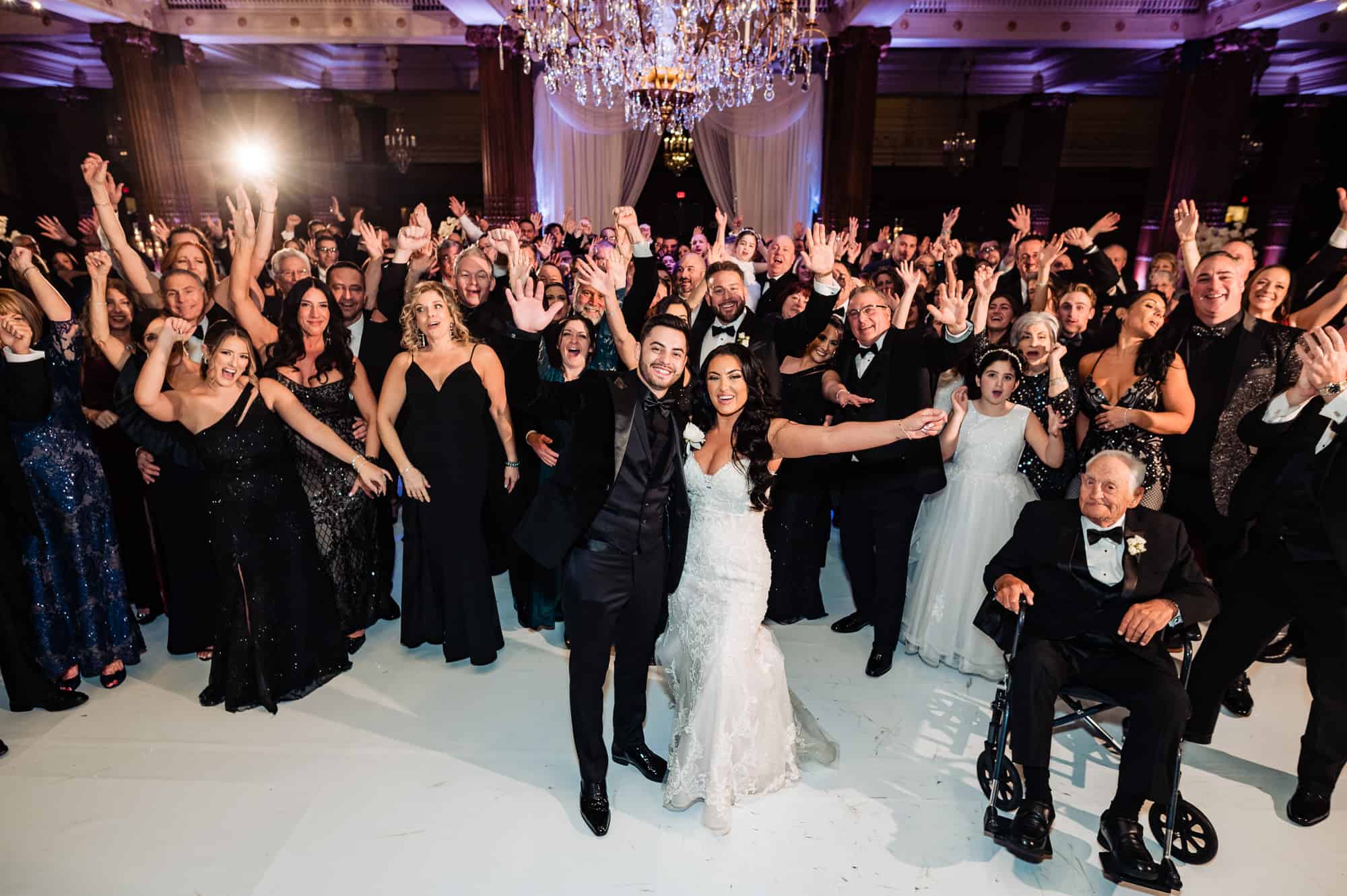 the newlyweds and guests cheer for the camera