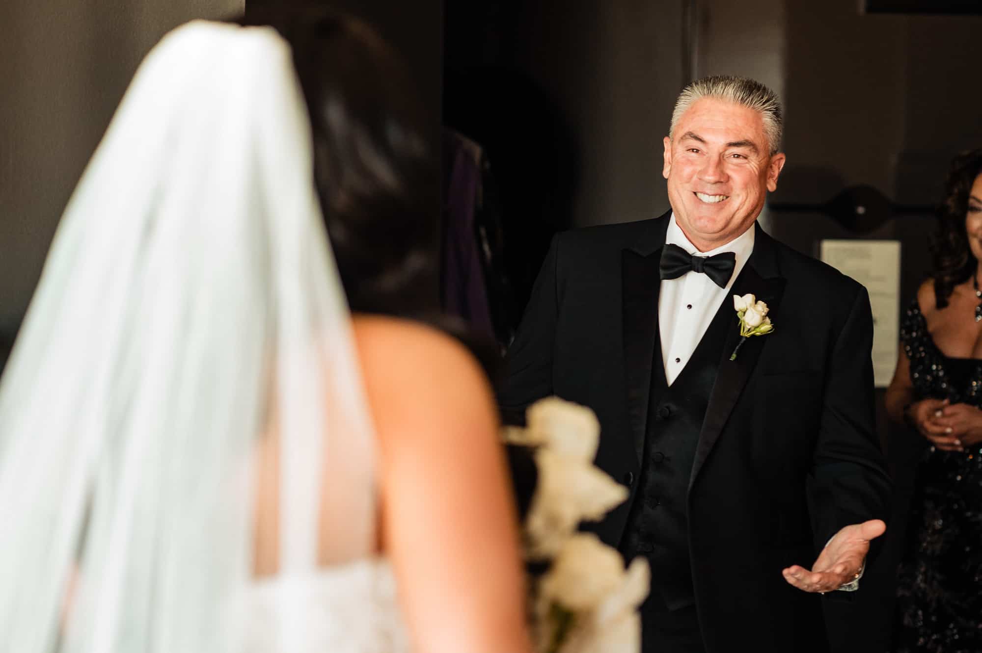 bride's father are all smiles upon seeing his daughter in her wedding dress