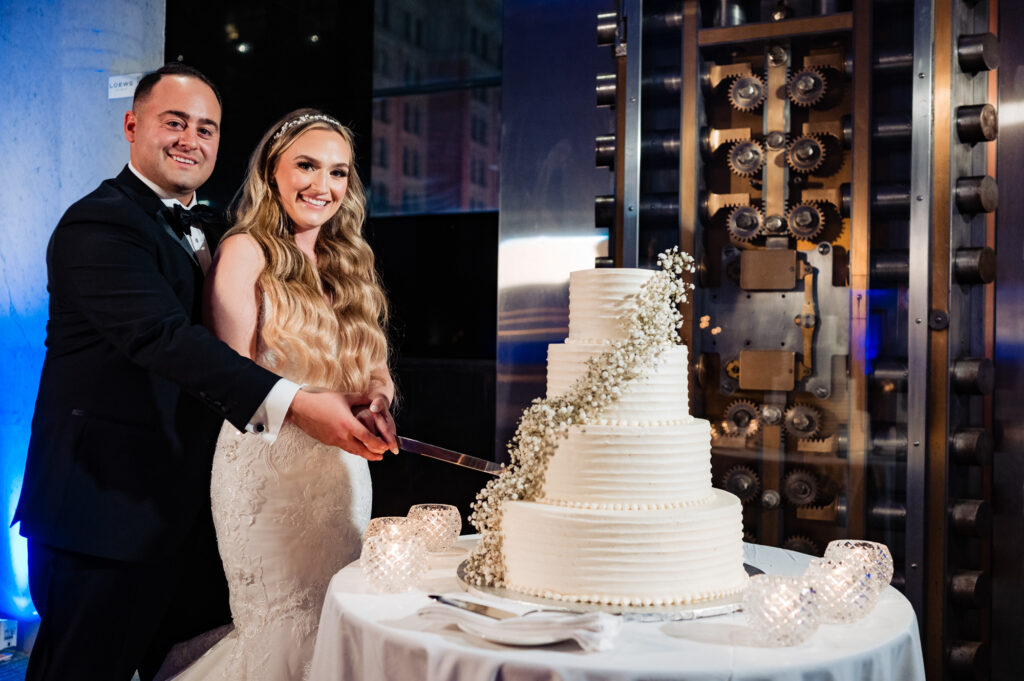 bride and groom cutting the cake