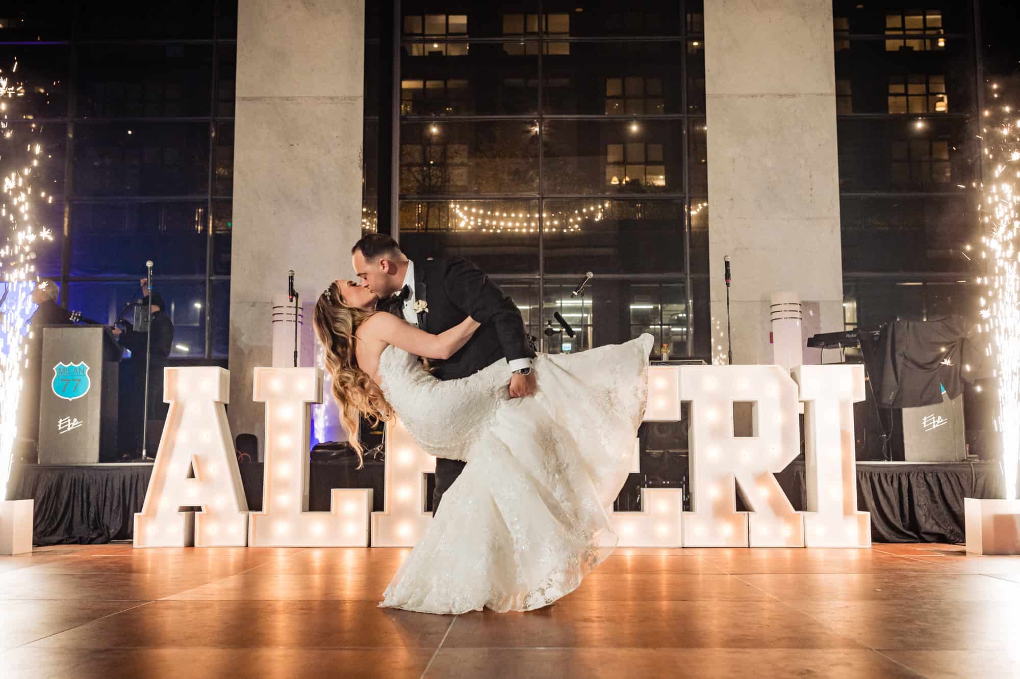 bride and groom kissing on their loews hotel philadelphia wedding reception