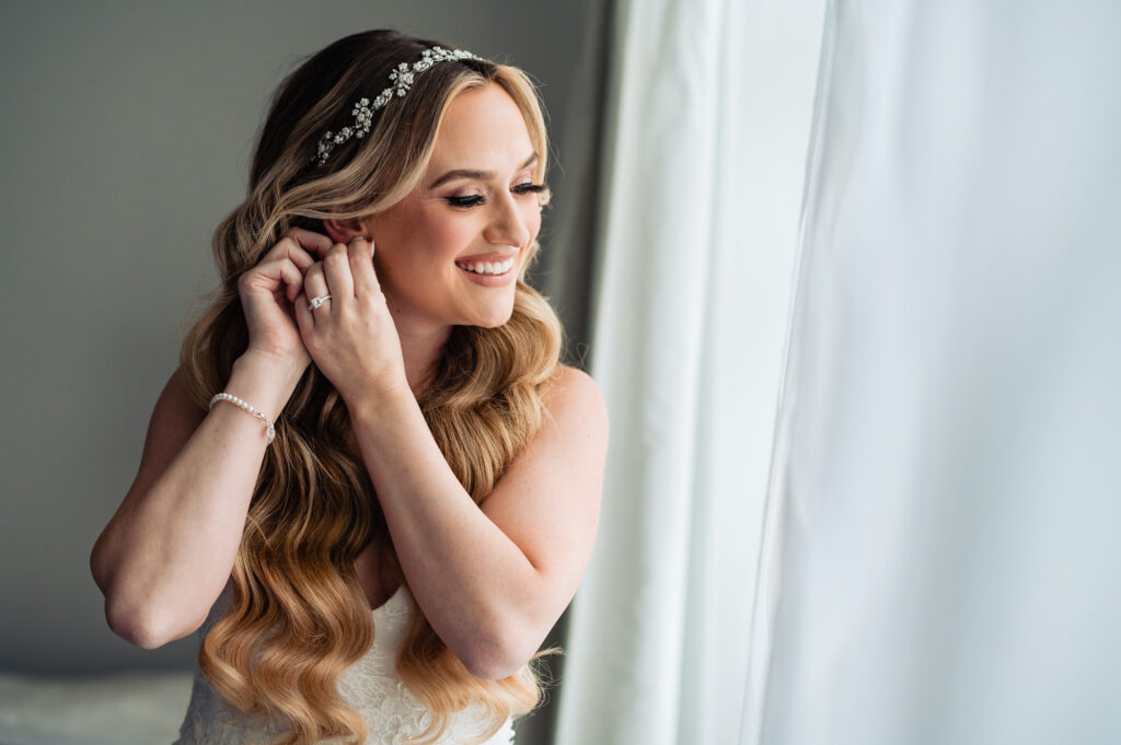 bride posing for the camera wearing her earring
