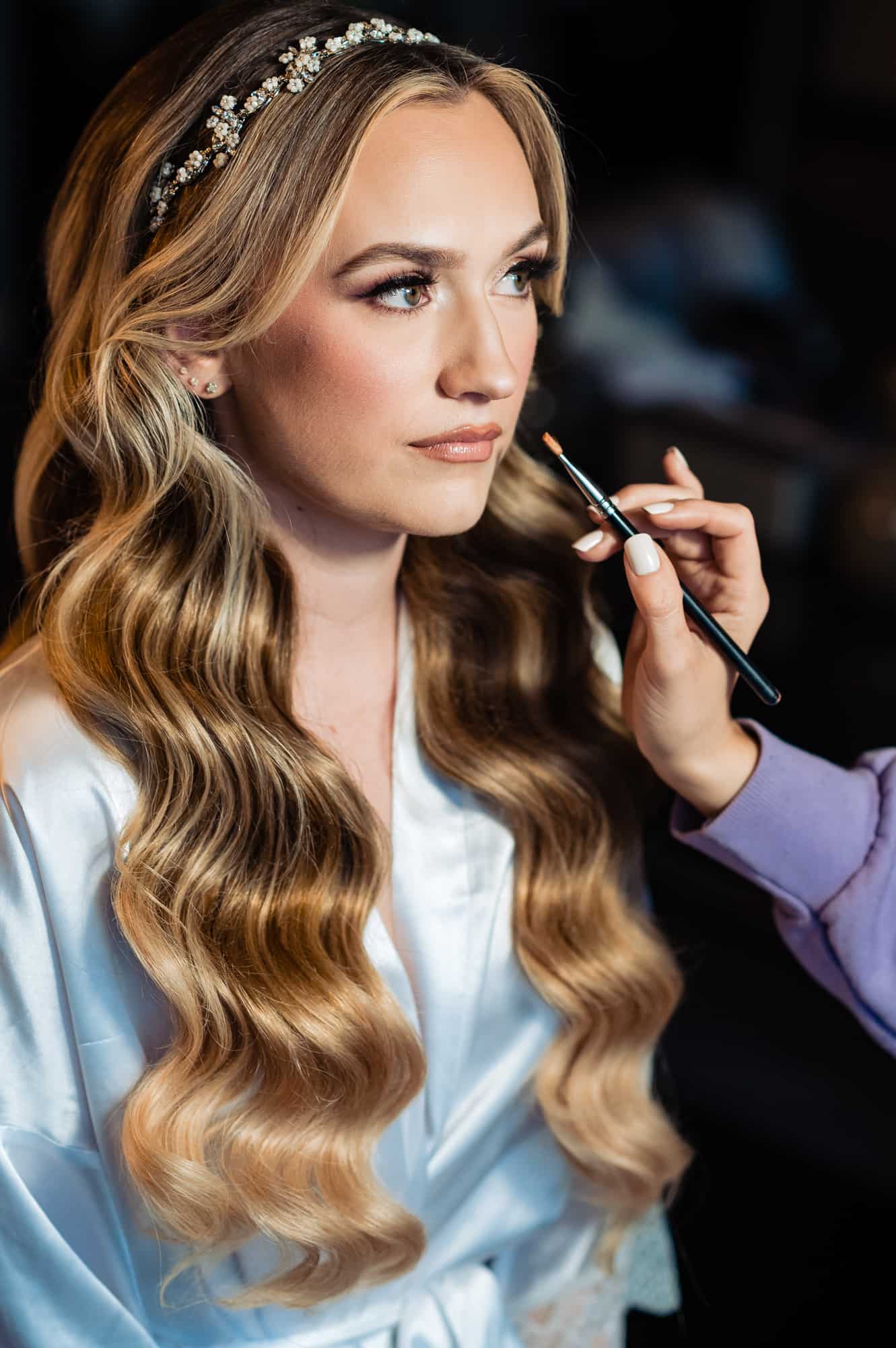 the bride getting her makeup done