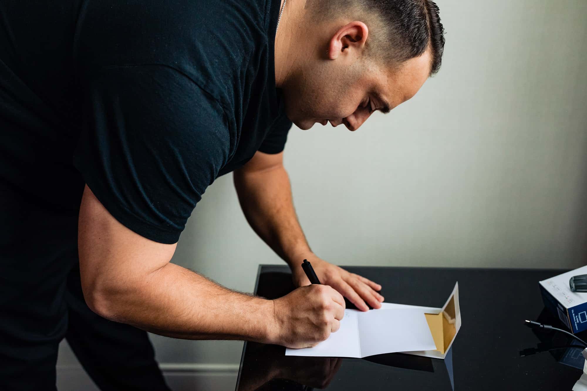 the groom writing his letter for the bride