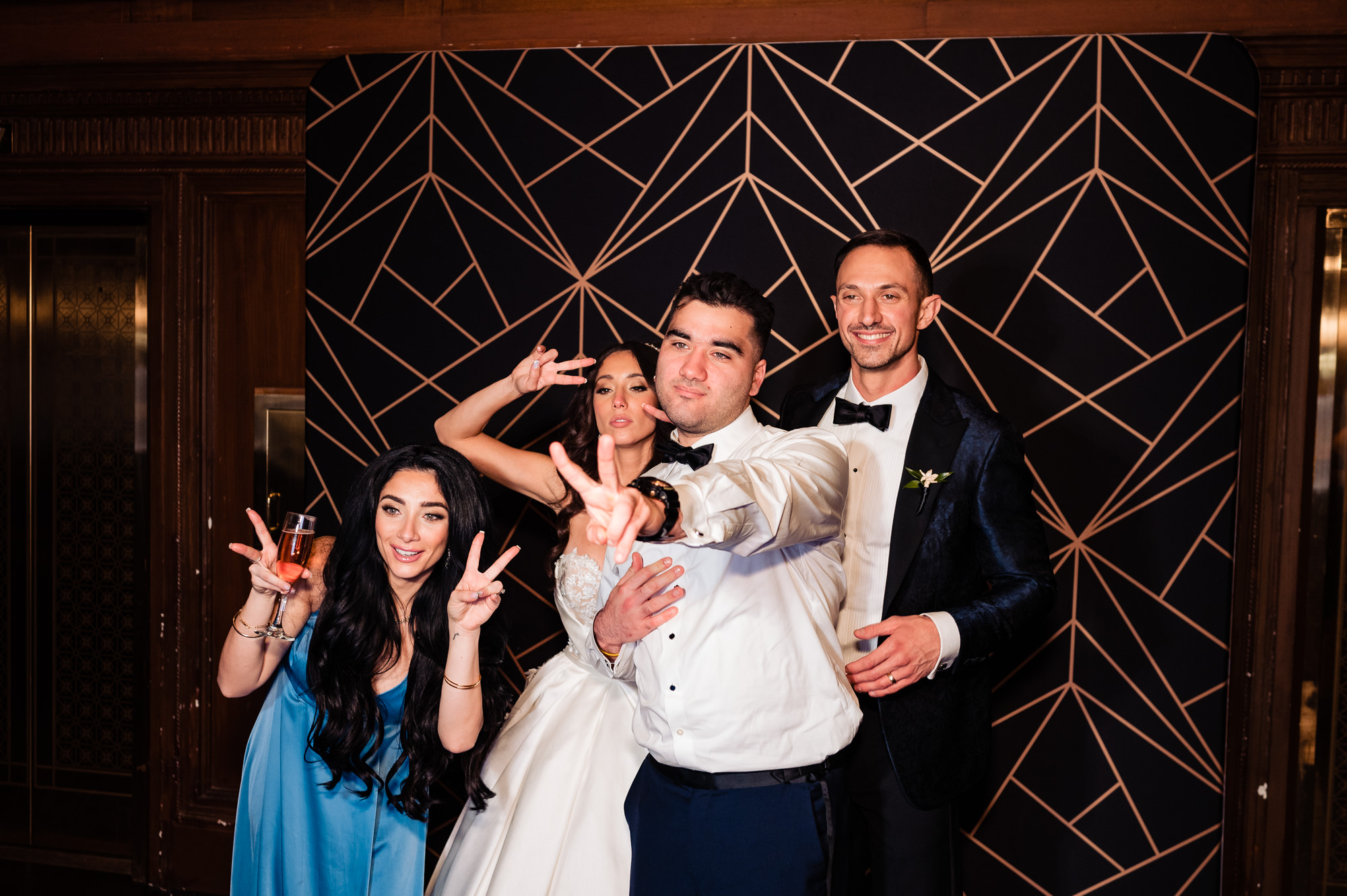 BRIDE AND GROOM POSING WITH THEIR FRIENDS