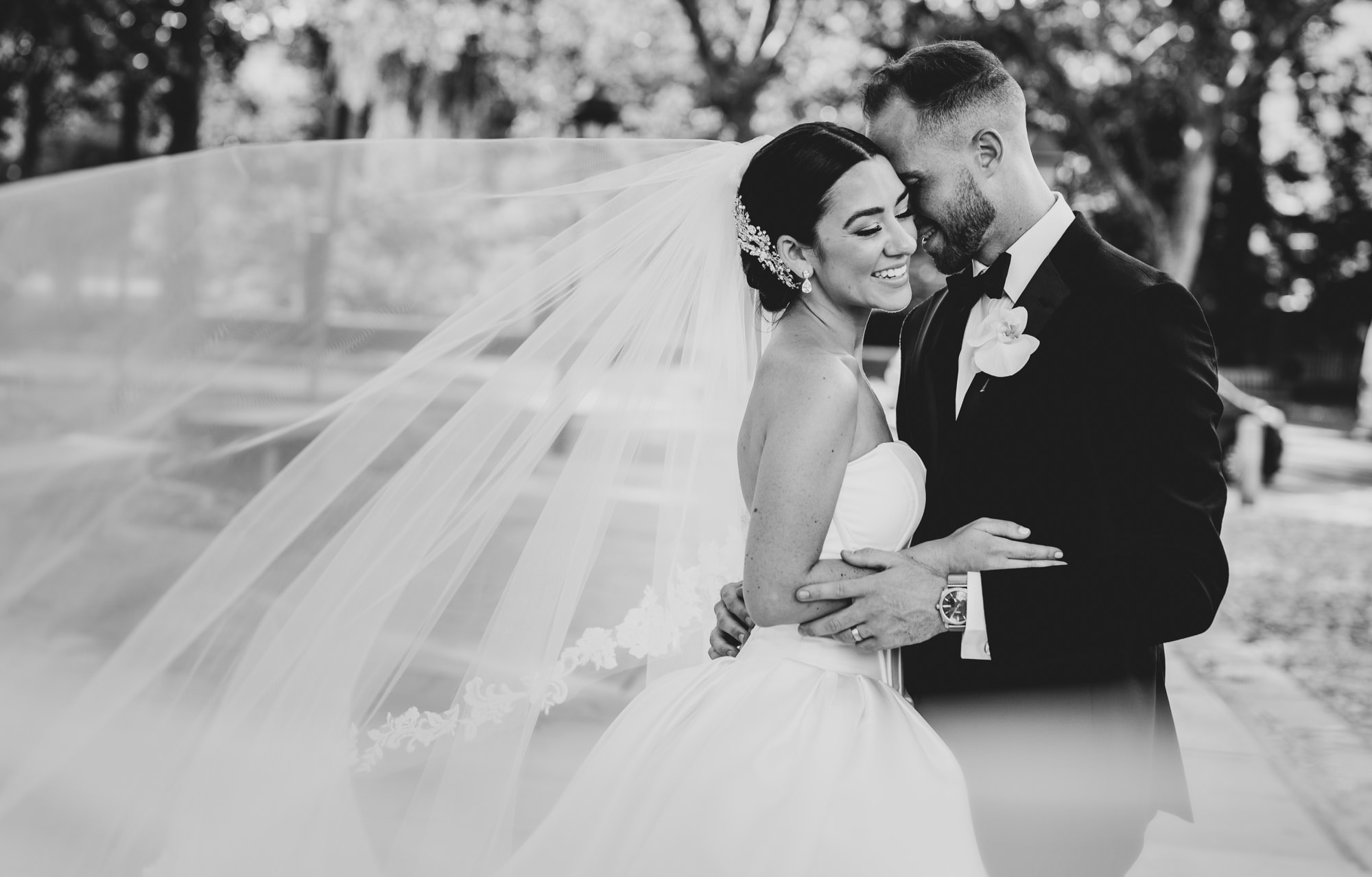 black and white shot of couple getting intimate after their wedding ceremony