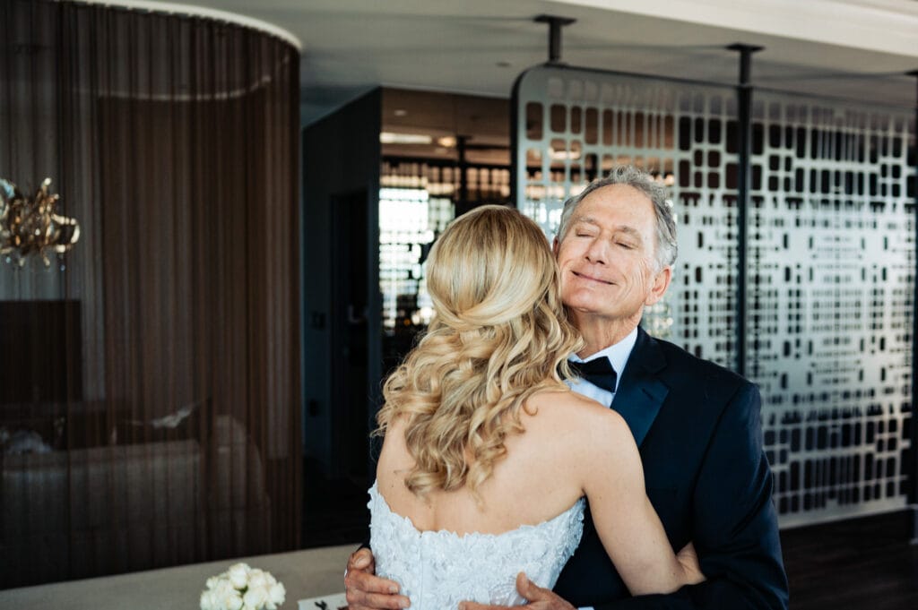 bride hugs her father before her wedding