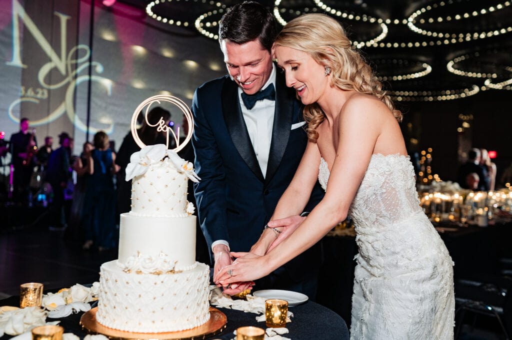 newlyweds cutting up their wedding cake