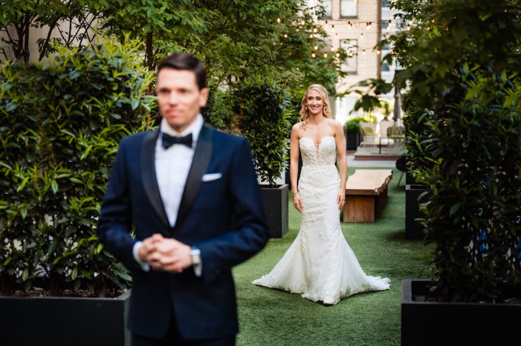 bride walking up behind the groom for the first look