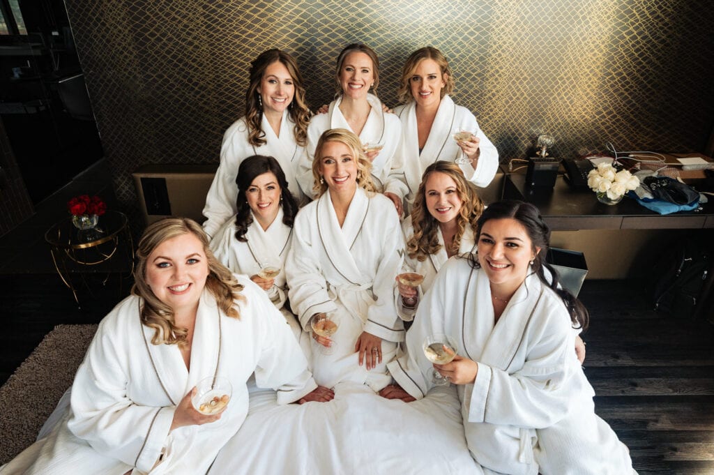 bride takes a pose with her her bridesmaids