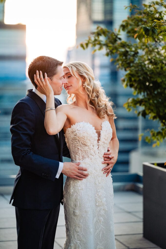 intimate moment of the groom holding the bride as they lean for kiss