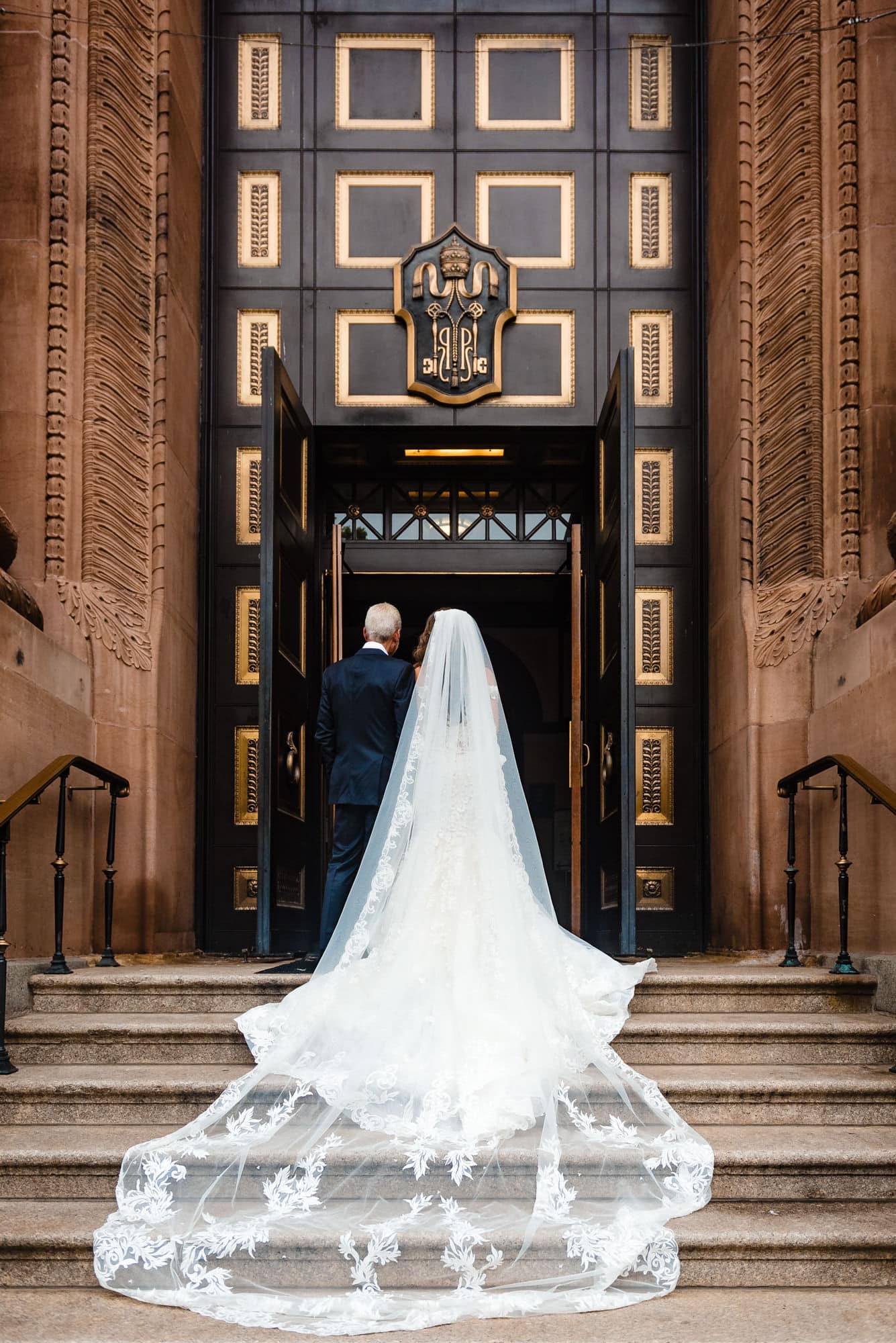 bride and her father at the entrance door of the church