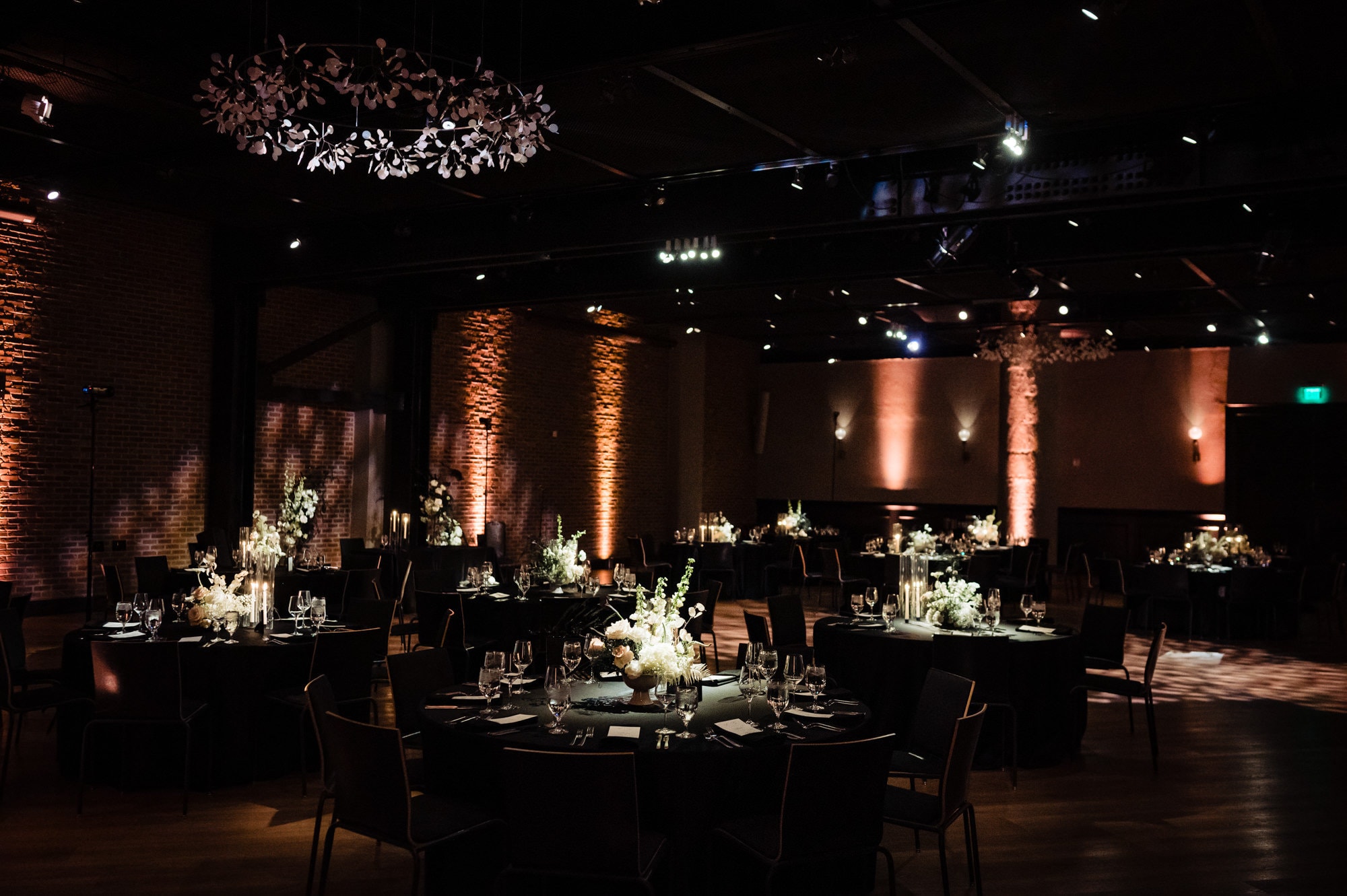 decorations at a wedding venue in Fitler club with florals as centerpiece and candles laid on the floor as accents