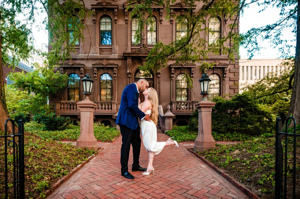 couple shares a tender kiss outside the hotel's ground
