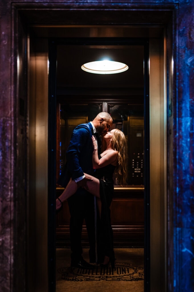 couple looks at each other lovingly in an elevator during their engagement shoot
