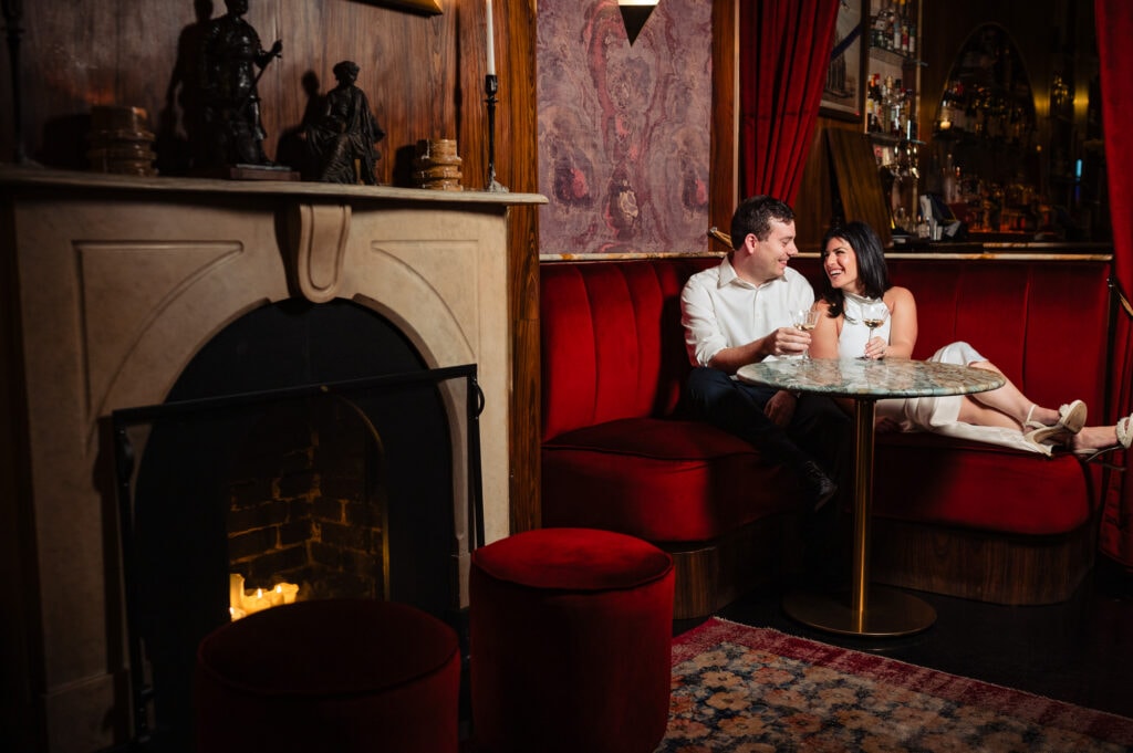 woman and man laughing as they sit close to eachother
