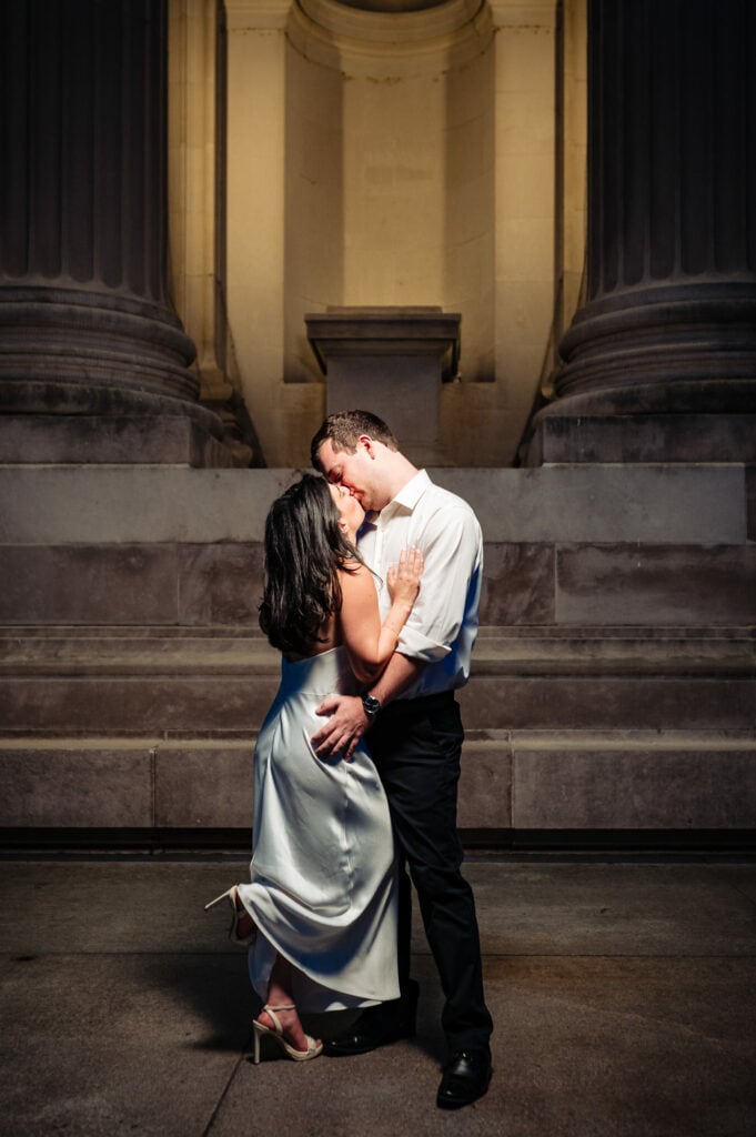 man and woman kissing as they hold each other close during their romantic Manhattan engagement photoshoot