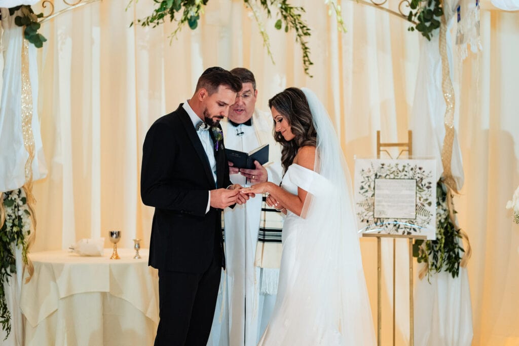 bride and groom is reading their vows