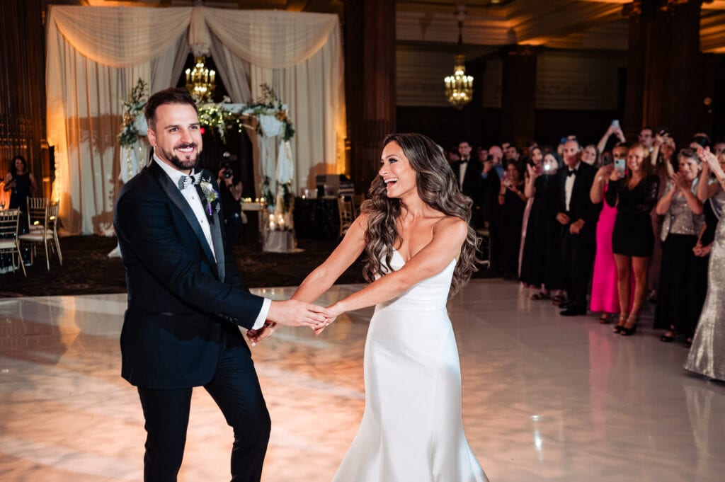the newlyweds share a light moment during their first dance