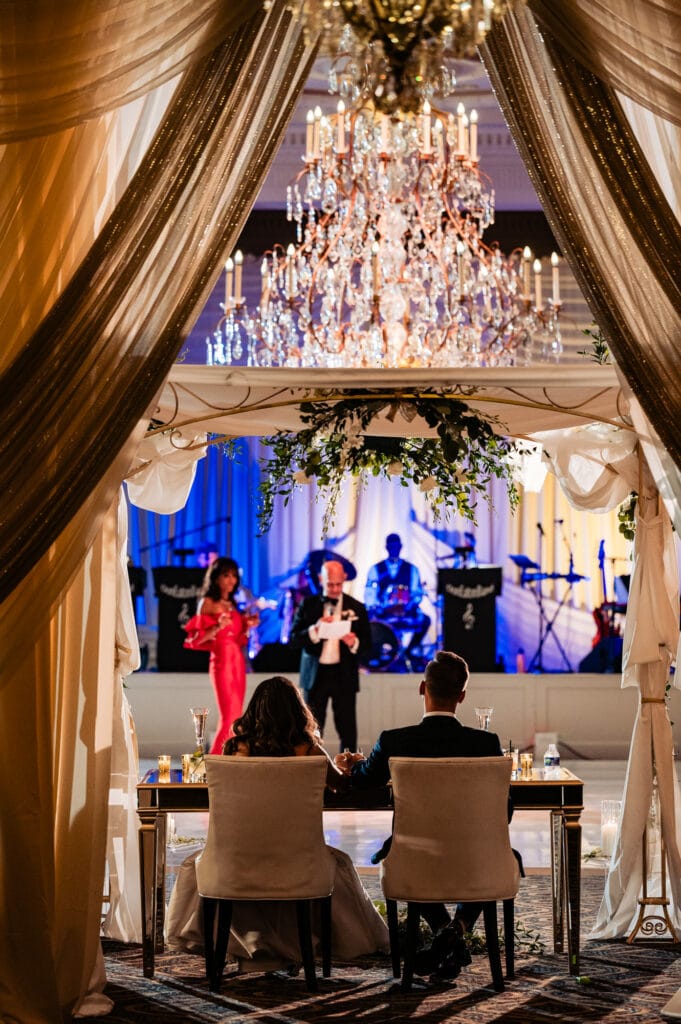 the newlyweds listening during a speech