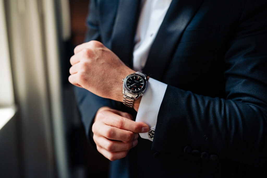 groom fixing his sleeve and showing off his watch