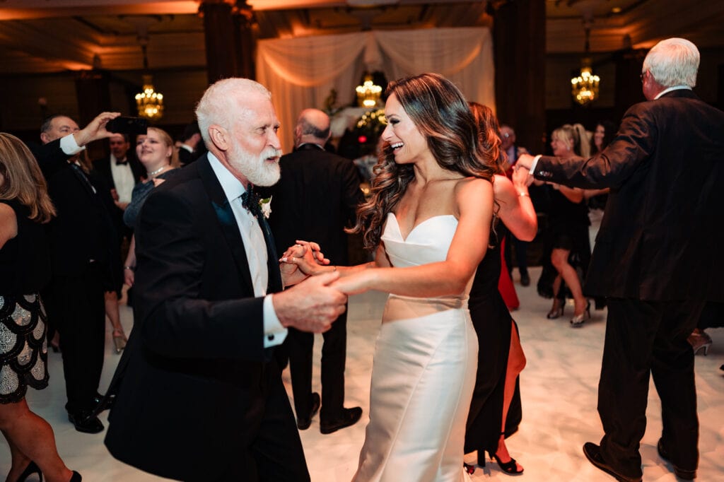 bride and an older male guest having fun on the dance floor