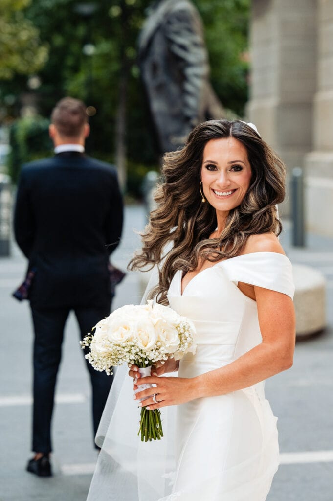 shot of the bride smiling at the camera before going to the groom for the first look