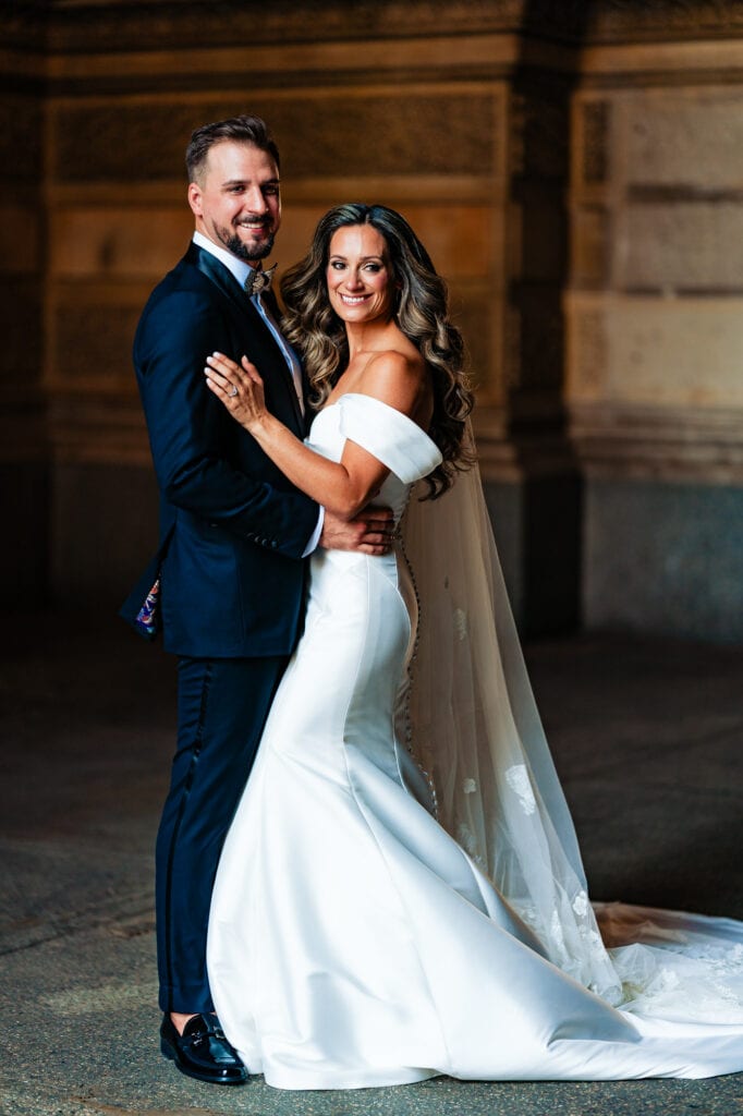 the newlyweds share a pose with a stunning architecture serving as their backdrop