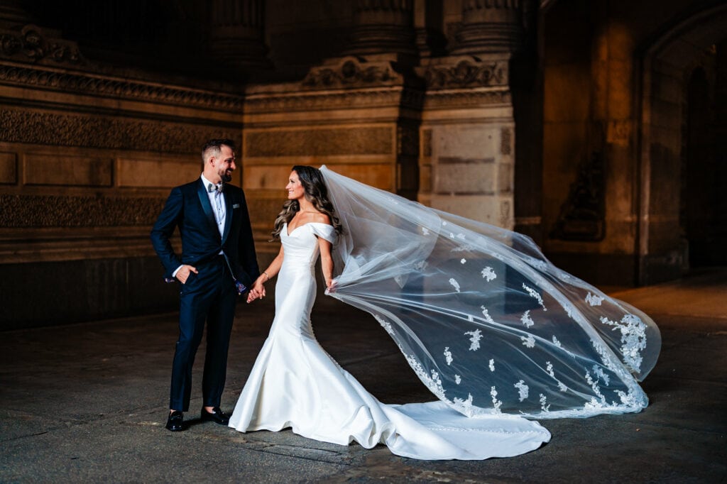 the newlyweds share a pose with a stunning architecture serving as their backdrop