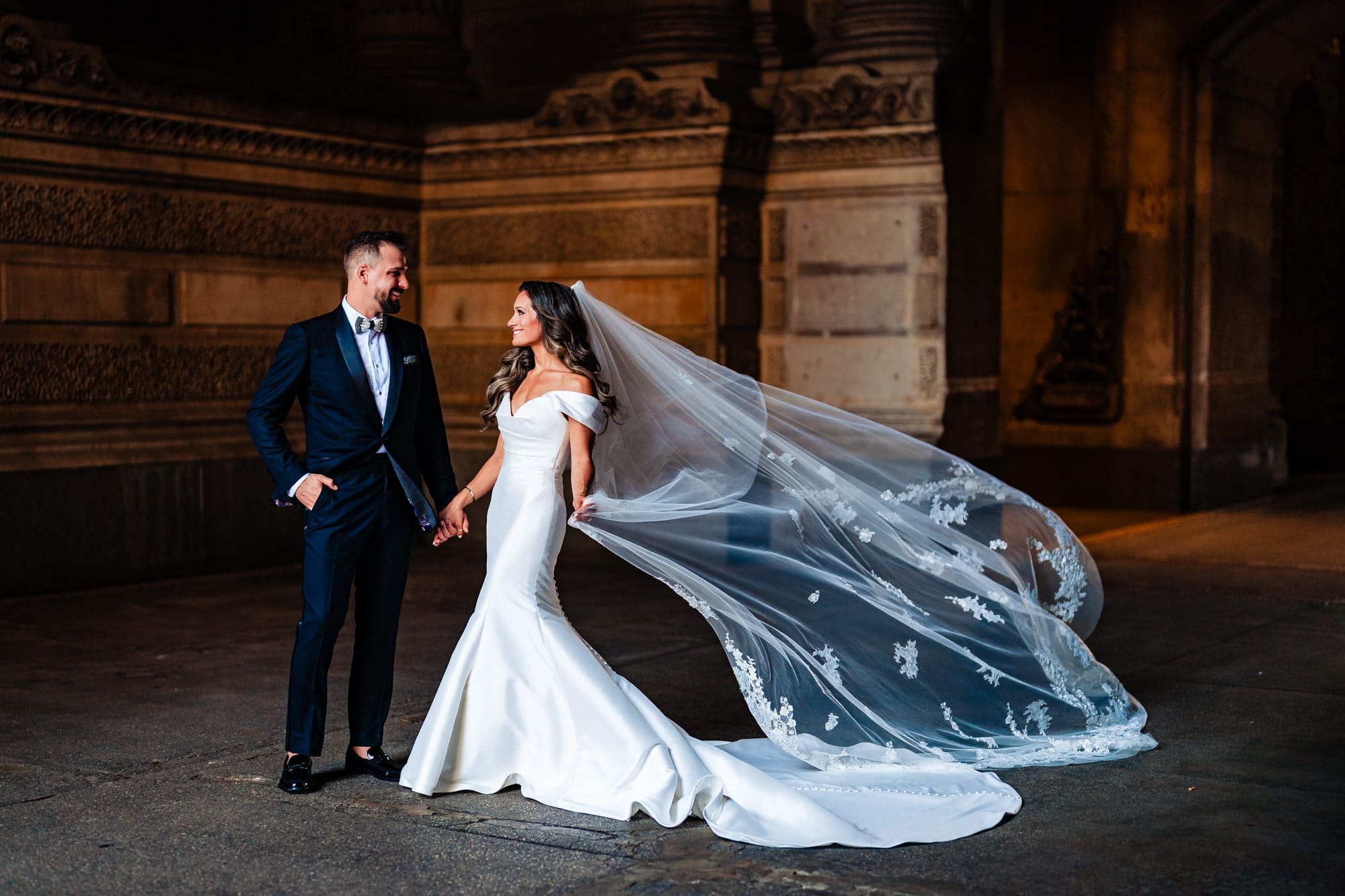 the newlyweds share a pose with a stunning architecture serving as their backdrop