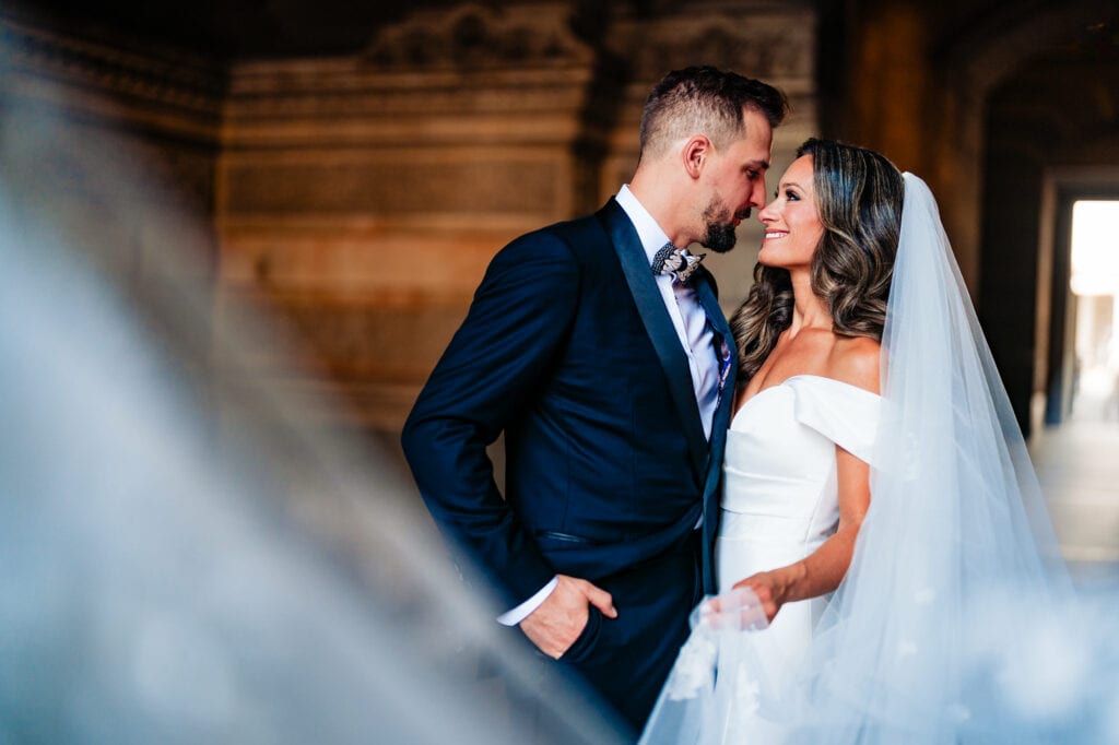 the newlyweds share a pose with a stunning architecture serving as their backdrop