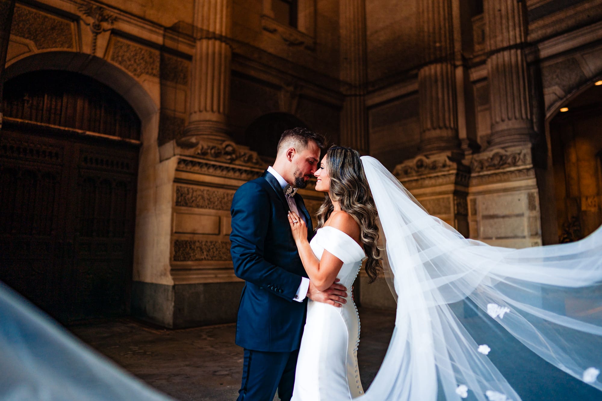 the newlyweds share a pose with a stunning architecture serving as their backdrop