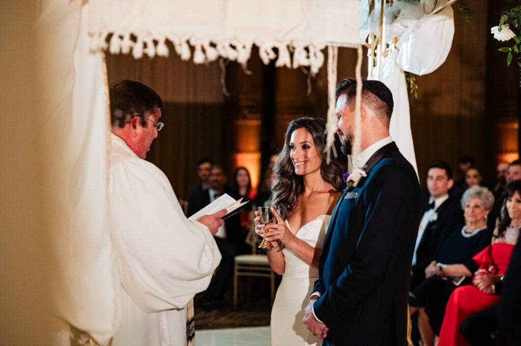 bride and groom listening intently to the wedding officiant