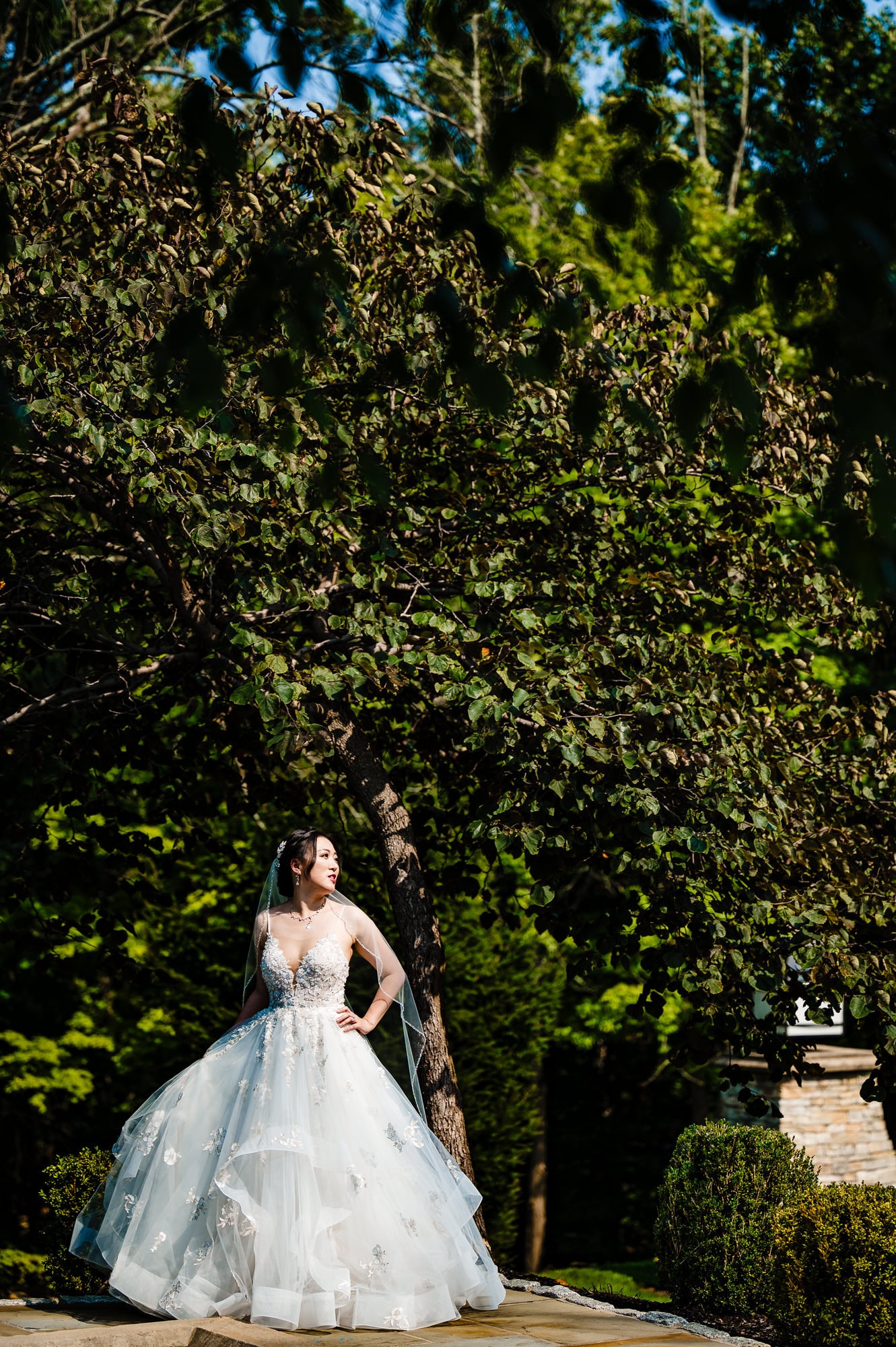 solo shot of the radiant bride in an outdoor garden