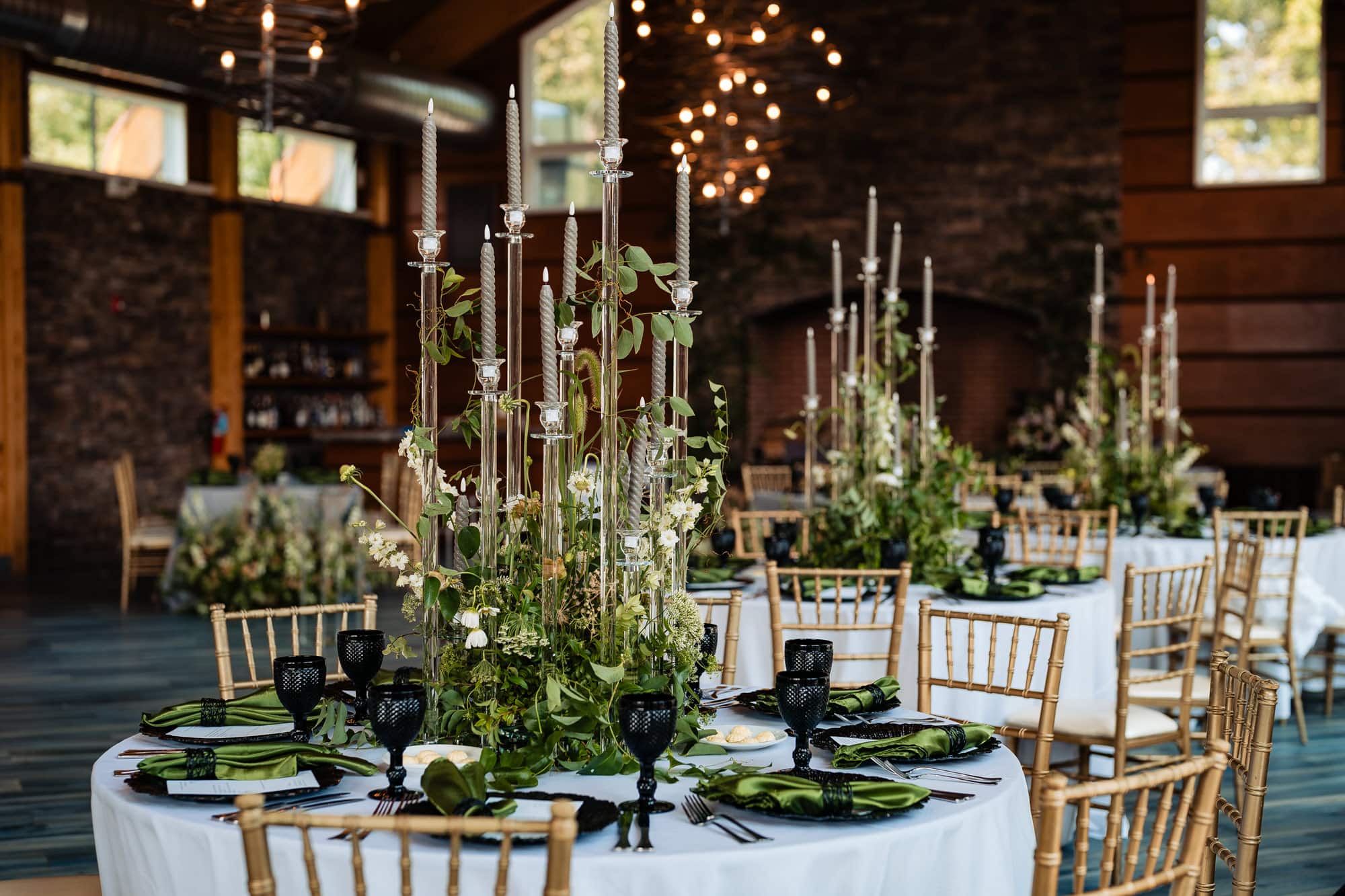the center table decor at the wedding reception with green plants as accents