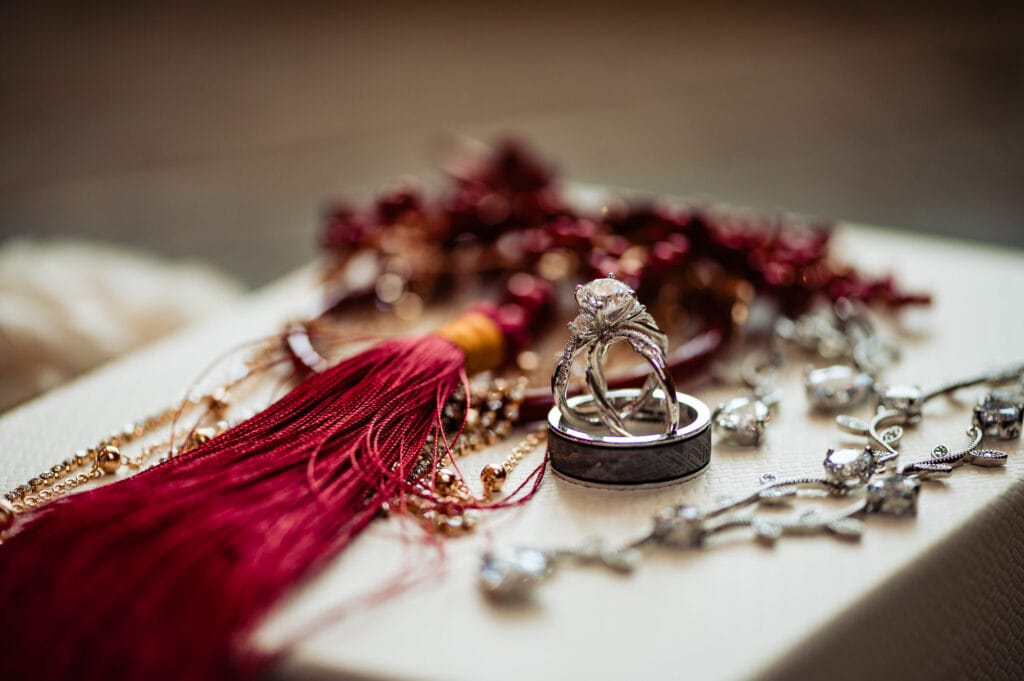 traditional chinese headress with red tassel, bride's necklace, a wedding band and bride's engagement ring